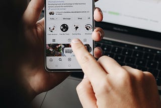 A person is holding a smartphone and browsing the SumUp Instagram profile.
