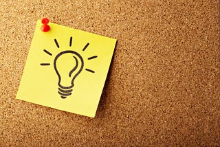 An image of a post it with a light bulb stitched to a wall