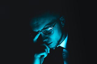 The writer pictures a man sitting with his eyes closed, in thought.