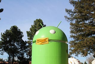 An Android statue with a face mask over it