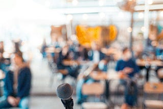 A stage with an audience, but the focus is on the microphone.