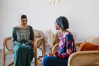 https://www.pexels.com/photo/women-in-hijabs-sitting-on-brown-wooden-armchair-7249398/
