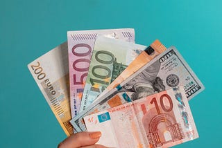 Cash earnings in a person’s hand — Write for WriterBay To Get Paid Well — If you are looking for a regular income while working from home with a flexible schedule and a variety of orders to choose from, WriterBay is for you!