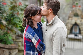 Here is a couple gently embracing each other, and the gentleman softly plants a kiss on her forehead, representing an apology after a silly argument.