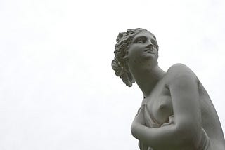 Back and white classic statue of a woman’s head and torso, looking over her shoulder.