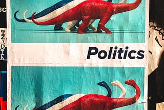 Sort of a flyer with a blue, then white, then red dinosaur shown vertically standing next to each other on a light blue background with the word Politics in the bottom right corner over a white background. This image is then repeated so the same picture appears one above the other on the flyer.