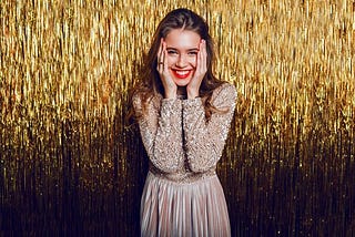 Young woman against a golden background