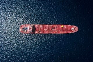 A ship in the sea with a bunch of goods on it.