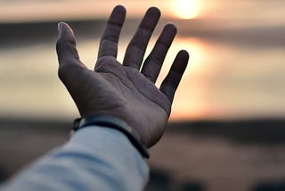 A hand and a sunset