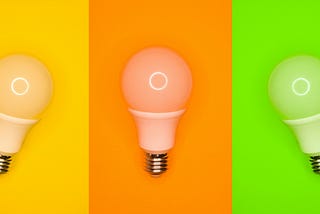 Three colored columns with light bulbs. Yellow, orange, and green.