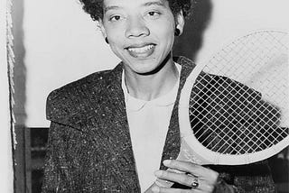 Althea Neale Gibson holding a tennis rocket.