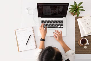 woman typing at computer