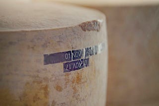 A big wheel of parmesan cheese indicating that this story is about Italian food.