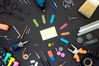 Tools laying on a black surface.