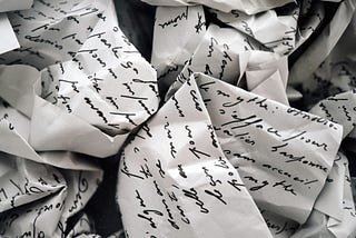 Old letters wrinkled up in black and white.