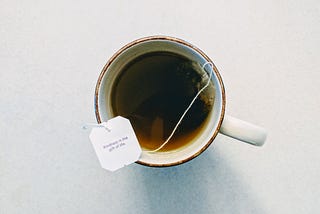 A mug of tea with a tag that says “Kindness is the gift of life”