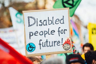 A handwritten sign that reads ‘Disabled people for future!’