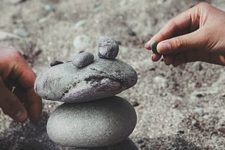 Placing stones on top of each other to form a stack