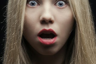 Blonde-haired girl with surprised look on her face