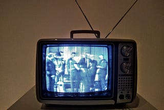 An image of an old television set showing a black and white tv show