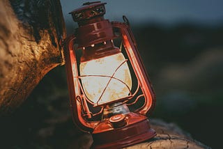 A lamp laid against a stone