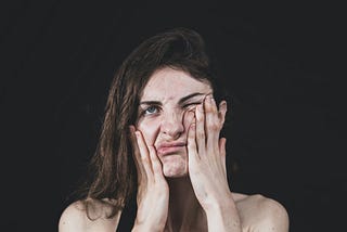Stressed woman covering her face with her hand