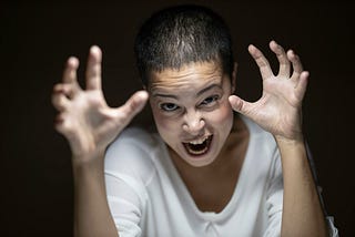 Angry woman growling, hands outstretched like claws
