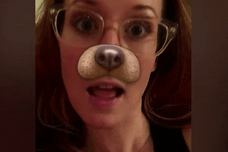 GIF of a woman with a licking dog filter