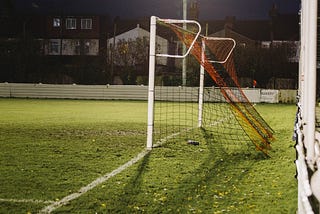 An empty football goal on a school field