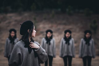 A woman looking back at a group of other women dressed exactly like her