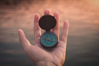 a compass on a hand