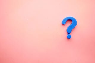 A 3D blue question mark on a coral-colored background