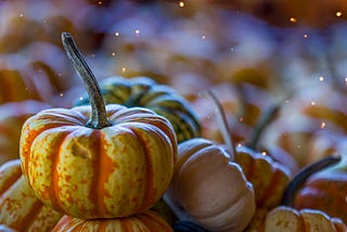 a stack of pumpkins with one close up