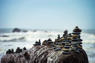 Pebbles piled in rows on a rock