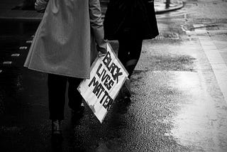 Woman with sign: “Black Lives Matter”