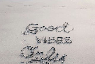 ‘Good Vibes Only’ written in the sand