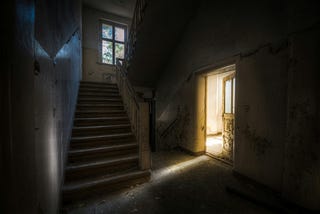 Stairs leading to a lit room