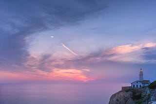 Twilight — daybreak overlooking the sea, lighthouse.