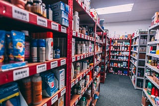 A warehouse has various racks containing unique SKUs. Each SKU has its own unique barcode label at its shelf position.