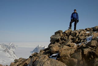 Author standing atop a mountain in Greenland