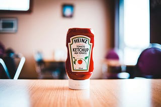 A bottle of Heinz ketchup on a table