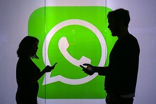 Two people: A man and a woman standing with WhatsApp logo in the background.