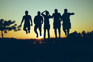 silhouette of five people jumping with sunset in background. tree to left. How Adaptogens Restore Balance in Astonishing Ways by Nancy Blackman. herbal medicine. herbs. ayurveda. traditional chinese medicine. adaptogens.