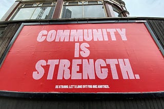 A poster depicting that community is strength