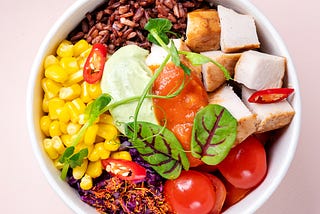 round bowl containing rainbow of foods