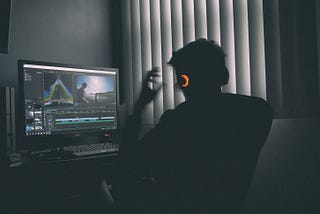 Man working on computer using Premiere Pro