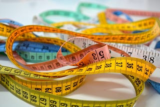 Collection of colorful tape measures.