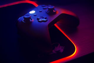 An Xbox Controller on an RBG Mousemat. This image is featured in Travis Kroon’s story on “How to save up to $358.67 on an Xbox Game Pass Ultimate Subscription”