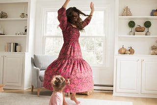 mom and daughter twirling in dresses