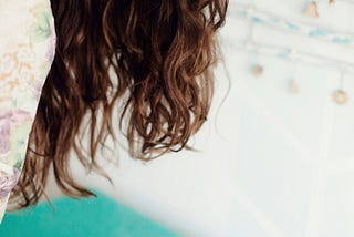 Photo of woman ironing on aqua ironing board.